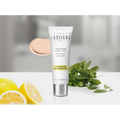 Bernard Cassiere Paris Tinted Cream 50ml tube, displayed with a beige cream swatch, fresh mint leaves, and sliced lemons on a white surface against a soft gray background.