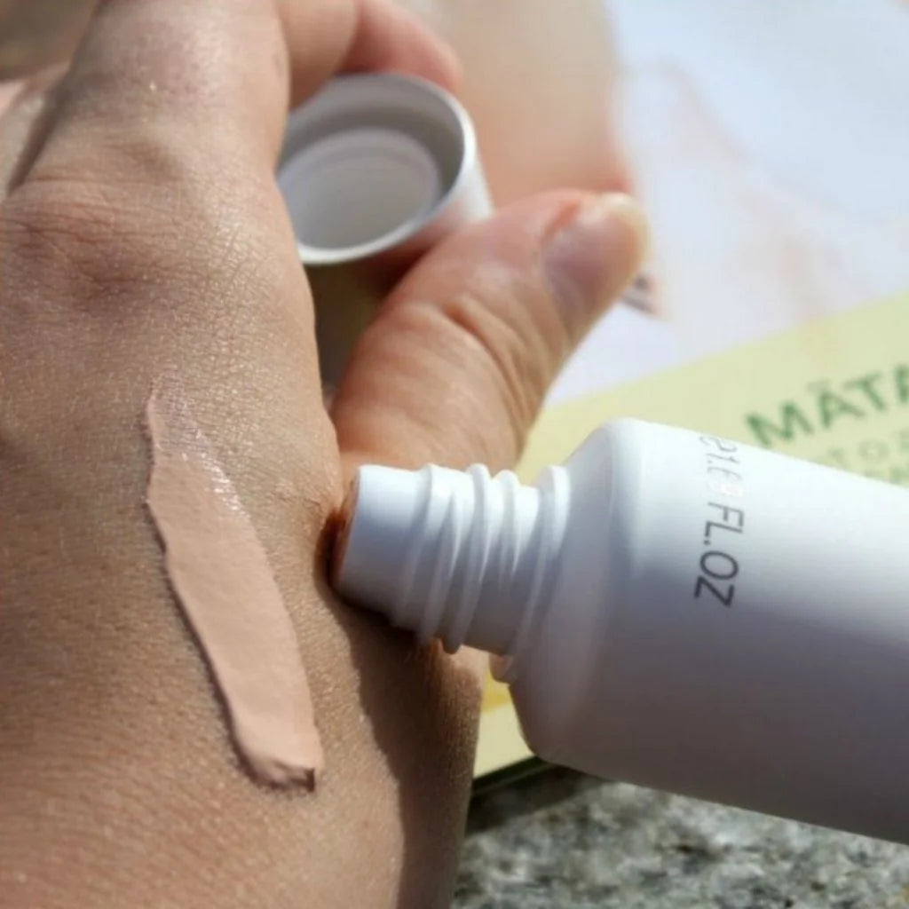 A close-up of a hand swatching bernard cassiere tinted cream