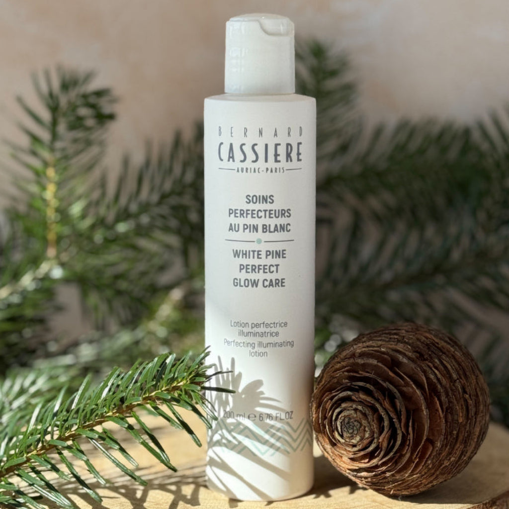 Bottle of Bernard Cassiere Illuminating Perfecting Lotion, acts as a light peel to revive skin's radiance and even its tone. 