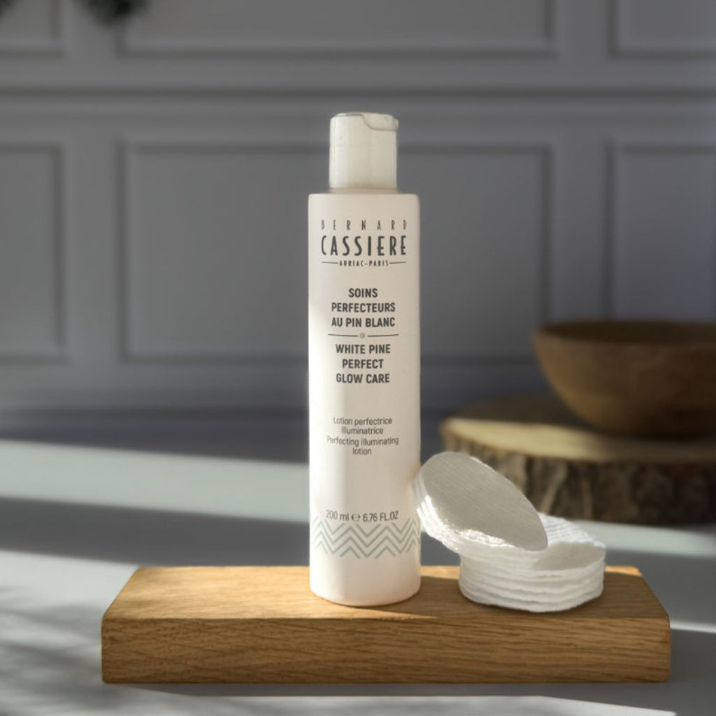 Bottle of Bernard Cassiere Illuminating Perfecting Lotion, acts as a light peel to revive skin's radiance and even its tone. 