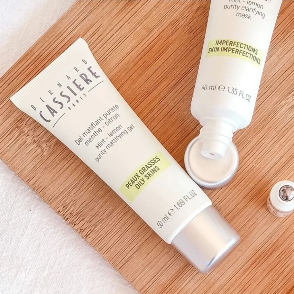 Bernard Cassiere skincare products on a wooden tray, including a tube of mattifying gel