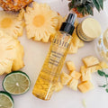 Pump bottle of Bernard Cassiere stretchmark and firmness body oil laying on cut up pineapple pieces 