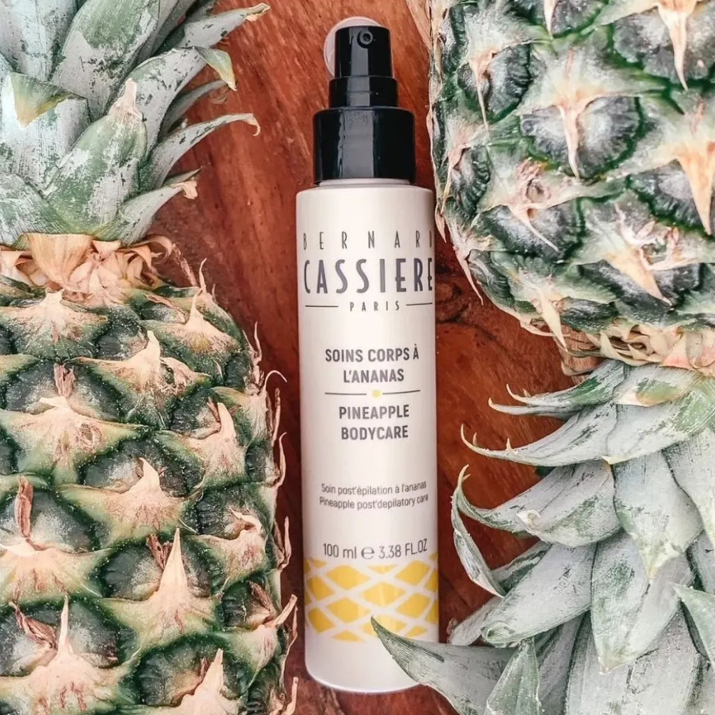 Pump bottle of Bernard Cassiere pineapple post depilatory care treatment with pineapples in the background 
